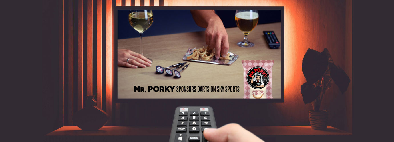 Image showing a person point a remote at a TV, which shows Mr. Porky Sponsors darts on Sky Sports.