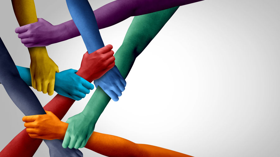 Different brightly coloured hands Holding Each Other by the wrist to create a strong stable link