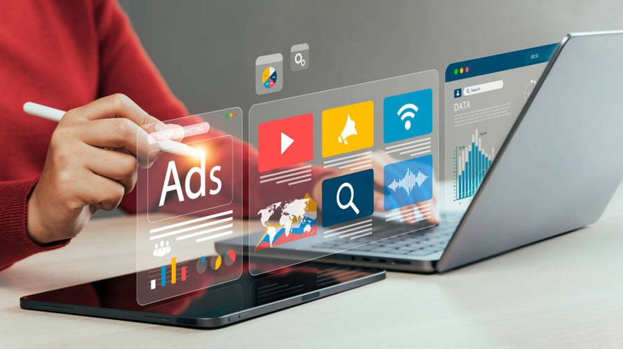 Person Scrolling Through Digital Media Ads on a Laptop and a Tablet